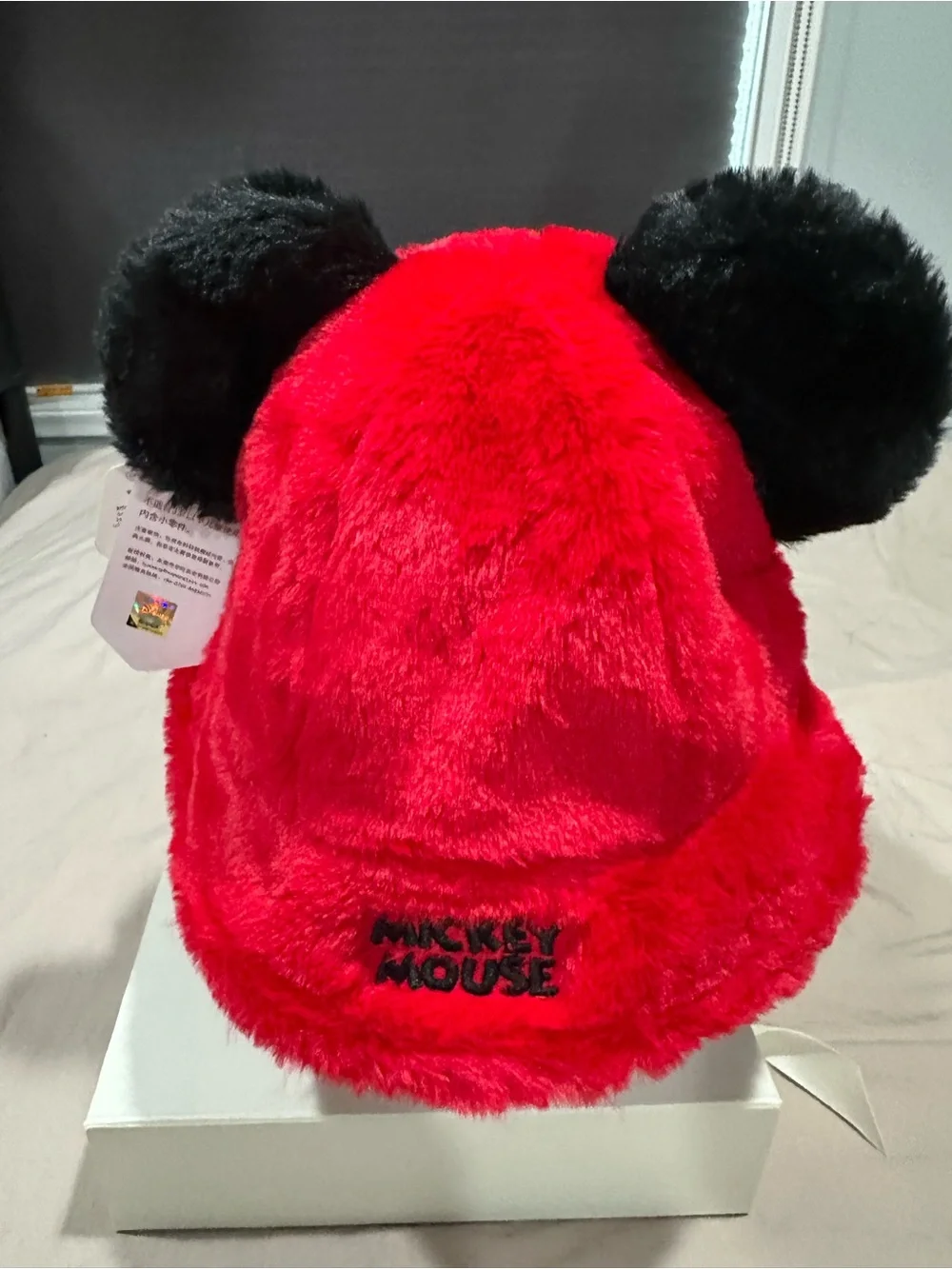 Red Plush Bucket Hat with Black Ear Accents and White Glove Details